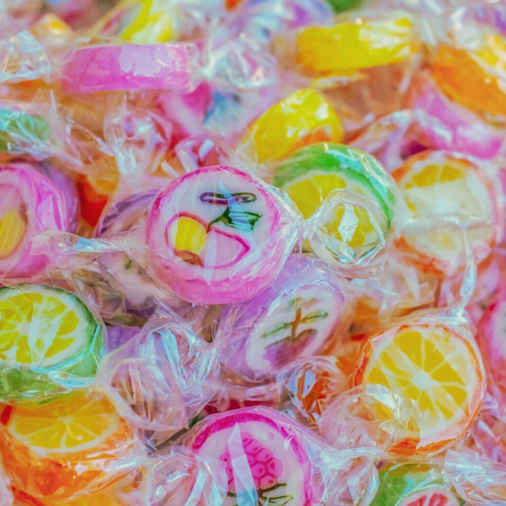 Vibrant close-up of colorful fruit-shaped candies, highlighting texture and sweetness.